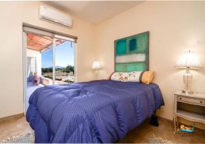 a bedroom with a purple bed and a window at Casa Desert Rose - Gated Community San Felipe Vacation Rental Home in Playa Hawaii +23 photos