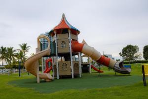 a playground with a slide in a park at Relax Loft on the beach Town Center Playa B in Río Hato