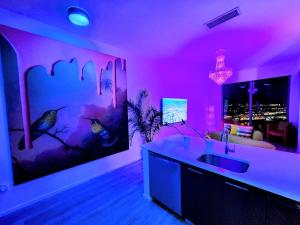 a purple kitchen with a sink and a living room at Marina Miami Penthouse- Downtown-Brickell 2BD-2BA in Miami