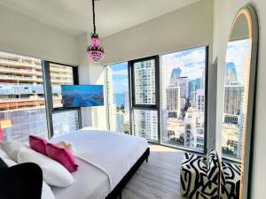 a bedroom with a large bed and large windows at Marina Miami Penthouse- Downtown-Brickell 2BD-2BA in Miami