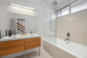 a bathroom with a sink and a shower and a tub at Waterfront Seabreeze Cowes in Cowes +23 photos