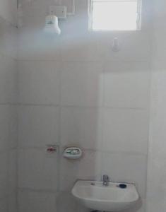 a white bathroom with a sink and a window at El Shaddai I in Santiago del Estero +3 photos