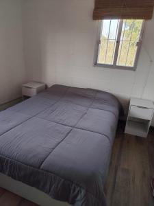 a bedroom with a bed in a room with a window at Hermosa casa a 50 metros del mar in Balneario Argentino