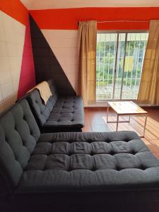 a living room with a couch and a table at Hermosa casa a 50 metros del mar in Balneario Argentino +12 photos