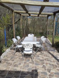a table and chairs on a stone patio at Hermosa casa a 50 metros del mar in Balneario Argentino