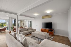 a living room with a couch and a flat screen tv at Waterfront Seabreeze Cowes in Cowes
