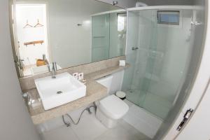 a bathroom with a toilet and a sink and a shower at Hi Adventure in Florianópolis +51 photos