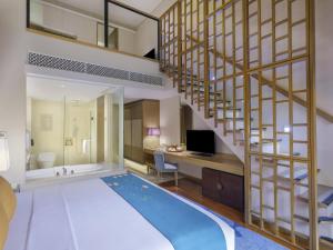 Postel nebo postele na pokoji v ubytování Mövenpick Resort & Spa Jimbaran Bali