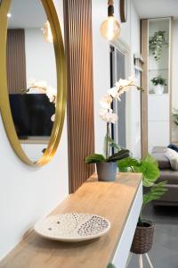 a living room with a mirror and a table at Cozy Stay in Paramaribo North in Paramaribo