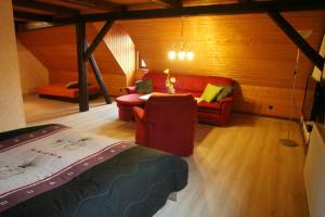 a room with a bed and a couch and a table at Wohnung In Ilfeld Mit Grill in Harztor