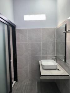 a bathroom with a toilet sitting on a counter at Gama Stay in Lovina