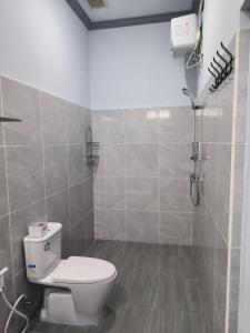 a bathroom with a toilet and a shower at Gama Stay in Lovina