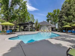 a swimming pool with chairs and umbrellas at 20 Minutes to Skiing in Midvale