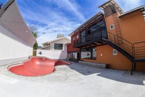 a red skateboard ramp in front of a building at Hi Adventure in Florianópolis