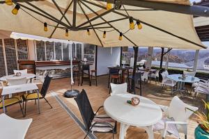 a restaurant with tables and chairs and a piano at Casa Dorotea in Playa del Cura
