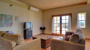 a living room with two couches and a coffee table at Casa La Vida Dulce in El Dorado Ranch San Felipe. 18-Hole Golf Course in Playa El Paraíso