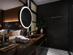 a bathroom with a sink and a mirror at Grand Mercure Khao Lak Bangsak in Khao Lak +153 photos