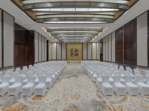 a room with rows of white chairs in it at Swissôtel Living Al Ghurair Dubai - Deira - Apartments in Dubai +104 photos