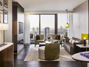 a living room with a couch and a table at Fairmont Quasar Istanbul Hotel in Istanbul