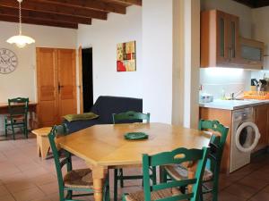 a kitchen and dining room with a wooden table and chairs at Gîte familial en pleine nature avec cour privée, Wi-Fi et proche randonnées à Le Mas-de-Tence - FR-1-582-132 in Le Mas-de-Tence
