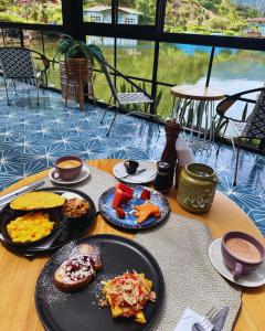 a table with plates of food on top at Hotel Lago Valdivia in Jardin +134 photos