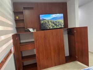 a living room with a tv on a wall at Villa Celeste in Macanal