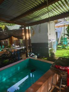 a swimming pool in a backyard with a table and chairs at Suan's Nook Guest House in Larena