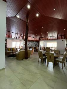 a dining room with tables and chairs in a room at Villa Celeste in Macanal