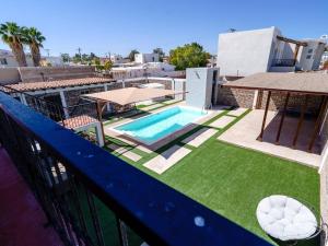 a balcony with a swimming pool and grass at Casa Barquito - Pool house in San Felipe in San Felipe
