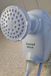 a blue electric hair dryer sitting on a table at Cantinho da Nonna in Morretes