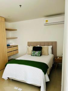 a bedroom with a large bed with a green blanket at EIRA TACK by Tack Real Estate in Santa Marta +17 photos