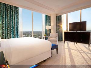 a bedroom with a large white bed and a large window at Fairmont Austin in Austin +199 photos