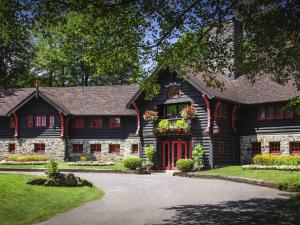 a log home with a red door at Fairmont Le Chateau Montebello in Montebello