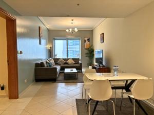 a living room with a couch and a table at Trinity Holiday Homes - Sheikh Zayed Road Near to Financial Center Metro Station in Dubai