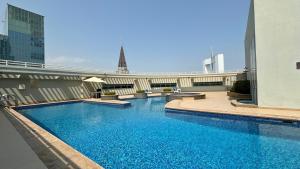 a large swimming pool on the side of a building at Trinity Holiday Homes - Sheikh Zayed Road Near to Financial Center Metro Station in Dubai