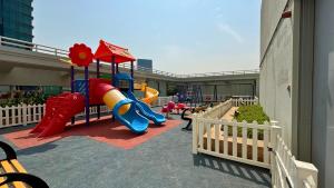 a playground in a building with a slide and a slideintend at Trinity Holiday Homes - Sheikh Zayed Road Near to Financial Center Metro Station in Dubai