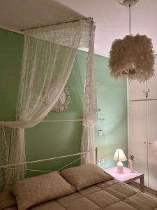 a bedroom with a bed with a canopy and curtains at Roseberry luxury apartment in Tríkala +16 photos