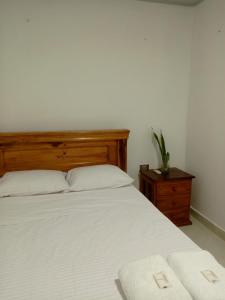 a bedroom with a bed with two towels on it at Casa Isabel in Santa Cruz de Mompox +3 photos