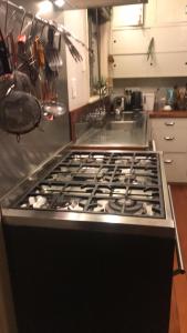 a stove top oven sitting in a kitchen at Lear House Oamaru in Motungarara