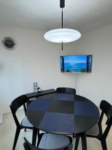 ein Esszimmer mit einem schwarzen Tisch und Stühlen in der Unterkunft NEW Gwangalli Beach 3-minute walk in Millak-tong