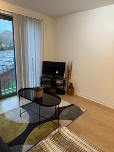 a living room with a coffee table and a television at Olive Den in Wolverhampton