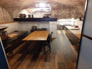 a large kitchen with a wooden table in it at Apartment near French Alps in Serrières-en-Chautagne