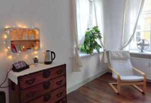 a room with a dresser and a chair and a window at Epic Location in Düsseldorf