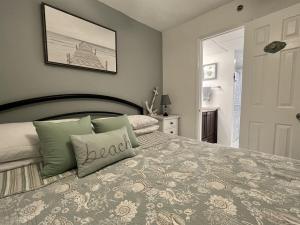 a bedroom with a large bed with green pillows at Amazing View Beach Front King Bed in Panama City Beach +12 photos
