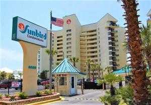 a hotel with an american flag in front of it at Amazing View Beach Front King Bed in Panama City Beach