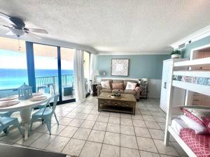 a living room with a bed and a table and a couch at Amazing View Beach Front King Bed in Panama City Beach