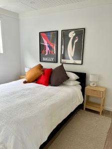 a bedroom with a bed with pillows on it at Little Red Gate Urban Retreat in Kingston