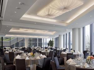 a banquet hall with tables and chairs and tablesktop at Fairmont Pacific Rim in Vancouver