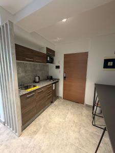 a kitchen with wooden cabinets and a sink at Departamento excelente ubicación in Comodoro Rivadavia