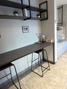 a desk in a room with a teddy bear sitting on it at Departamento excelente ubicación in Comodoro Rivadavia +3 photos